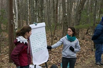 Two women presenting the Leave No Trace concept to the Winchendon Scouts