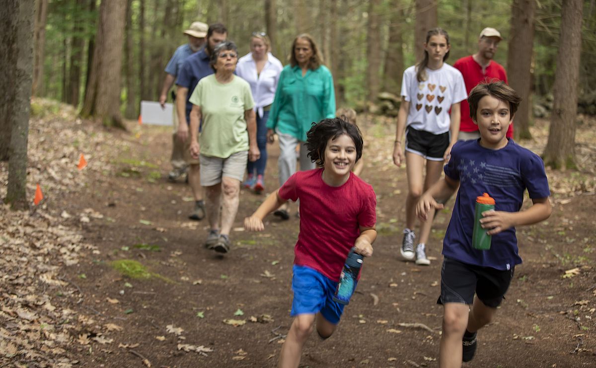 Kids running in the woods recreationally