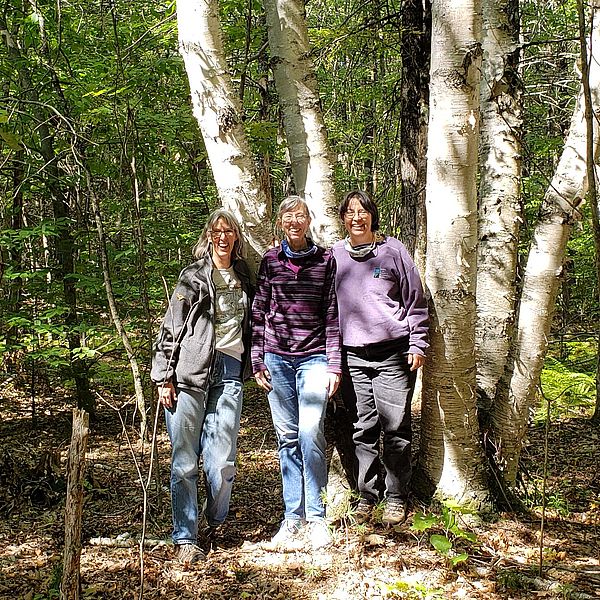 Ruth Smith, Karen Clark, and Beth McGuinn on the land