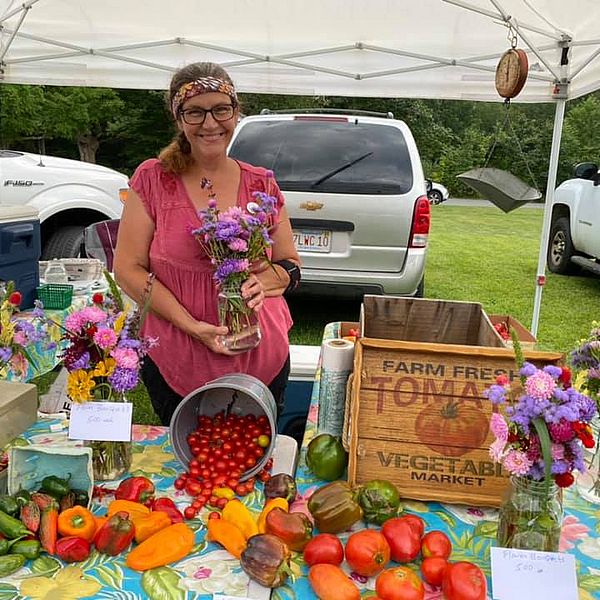 Rachel Gonzalez, Orange Farmers Market Manager, with flowers.