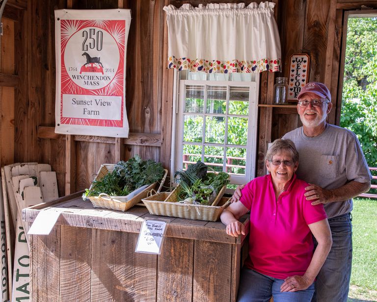 Sunset View Farm owners Chuck and Livvy Tarleton at their farm stand in Winchendon