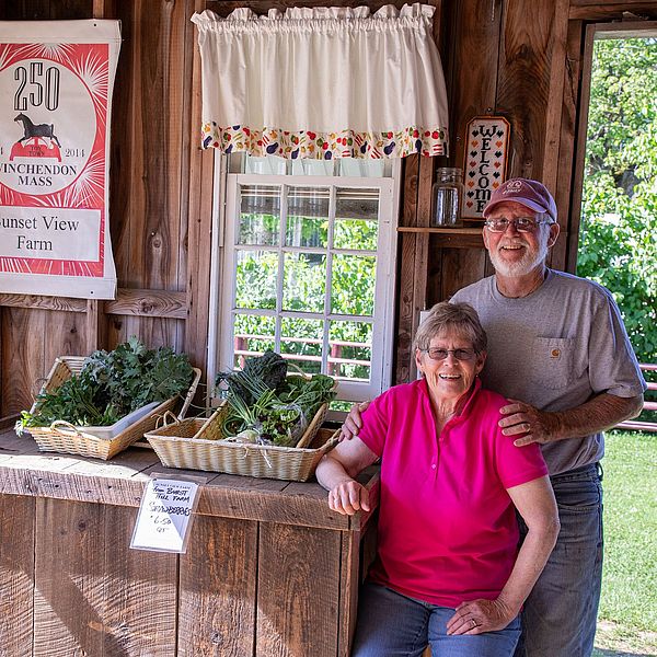 Sunset View Farm owners Chuck and Livvy Tarleton at their farm stand in Winchendon