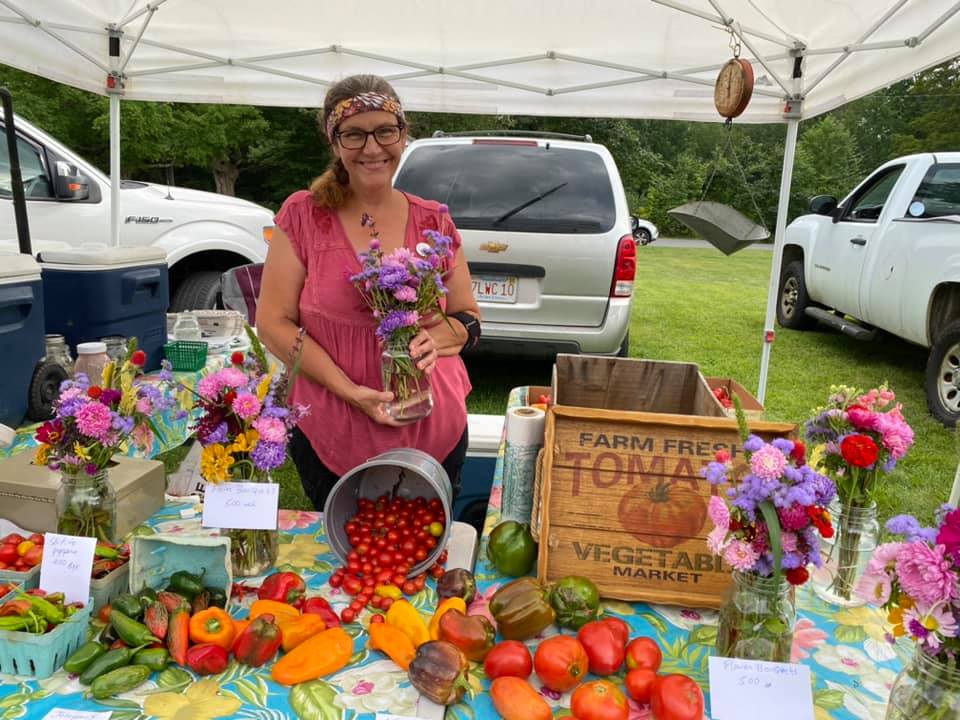 Rachel Gonzalez, Orange Farmers Market Manager, with flowers.